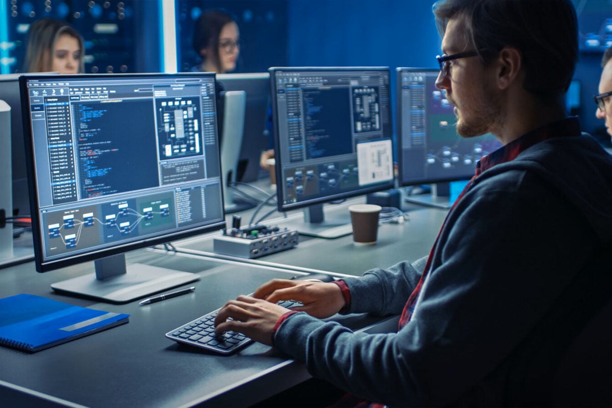 a team of cyber security professionals working on their respective computers
