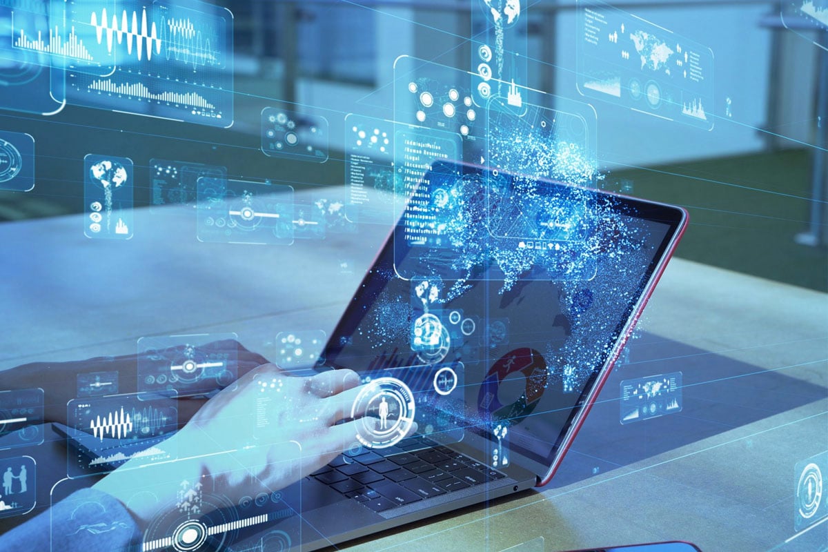 a woman working on her laptop with an overlay of digital images and renderings
