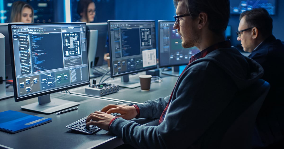 Programer Working on Desktop Computer