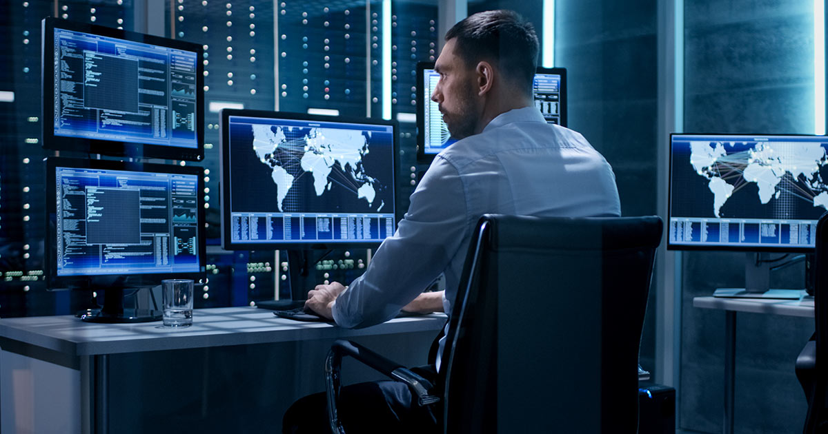 Technical Controller Working at His Workstation with Multiple Displays