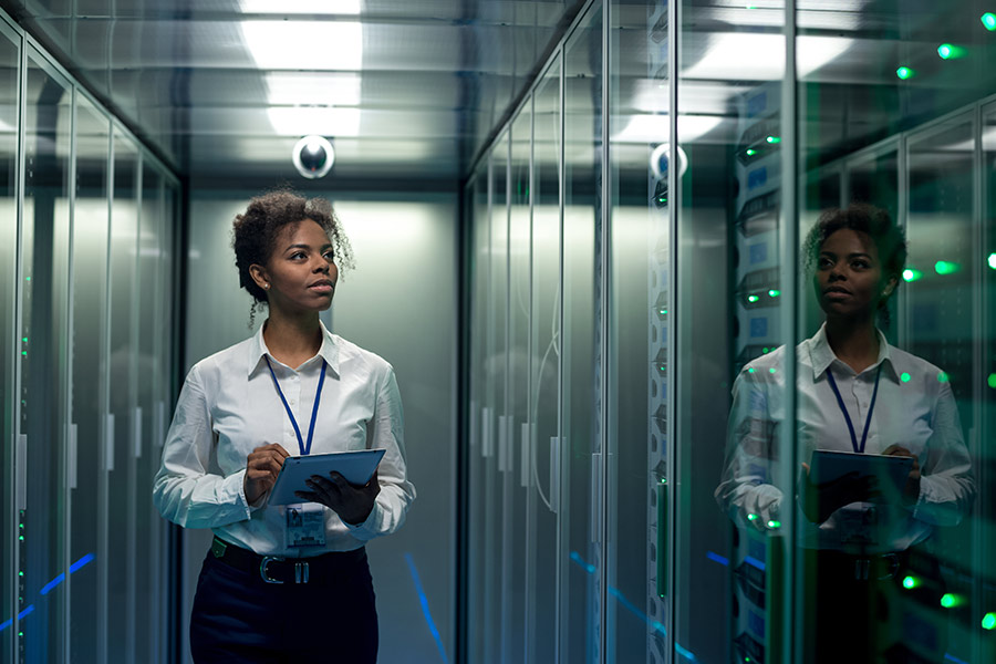 Female technician inspecting server room