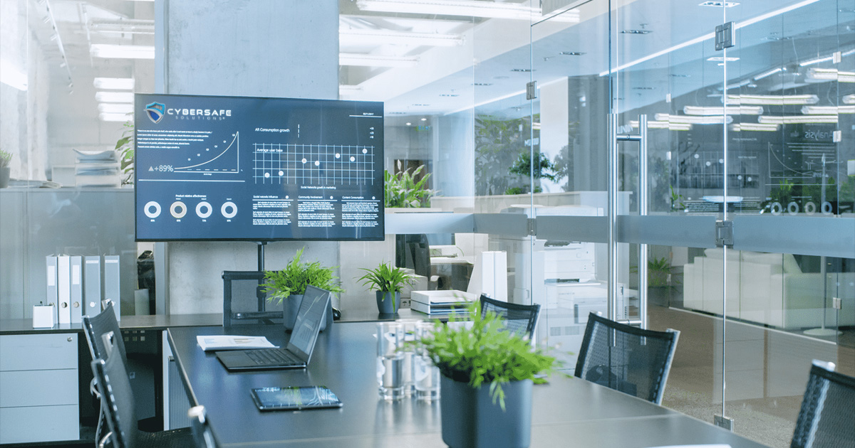 Modern conference room with tv displaying analytics at the helm of the table