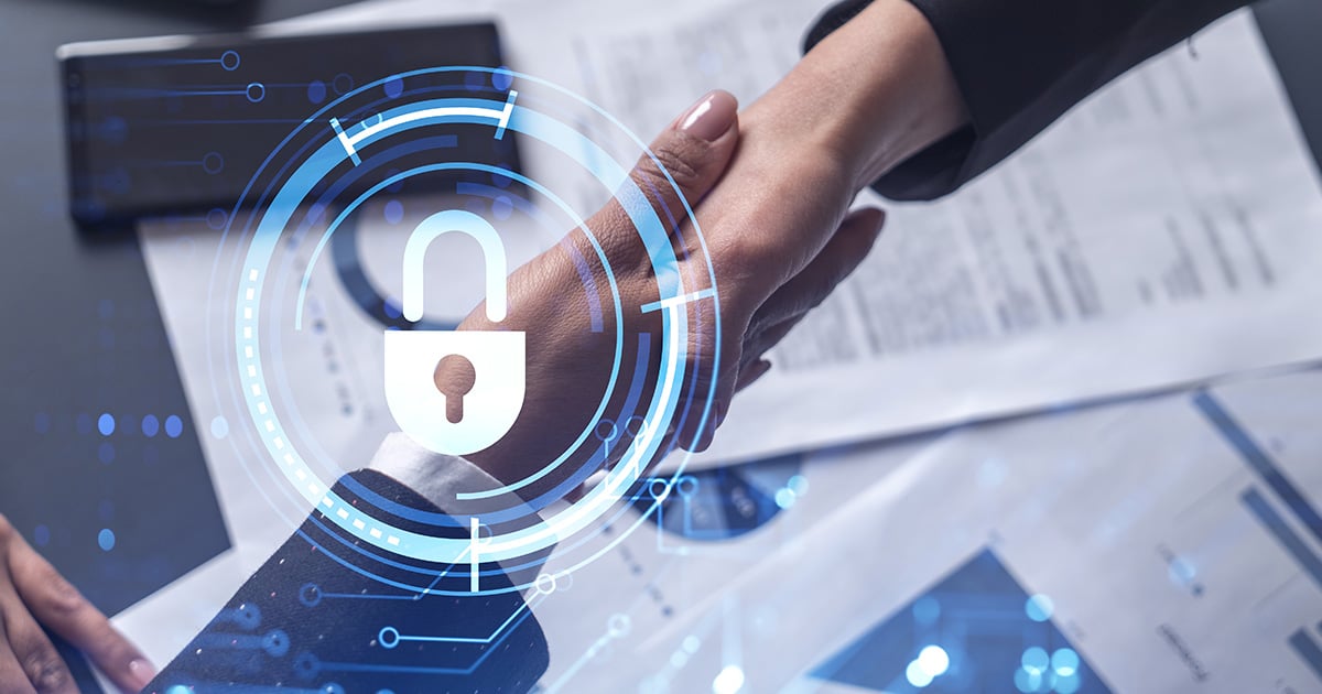 Handshake of two businesswomen who enters into the contract to protect cyber security of international company. Padlock Hologram icons over the table with documents.