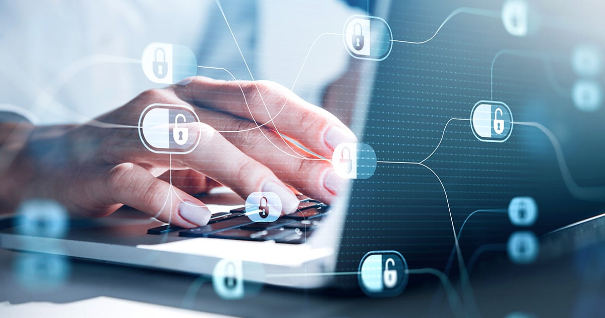 Business Woman hands typing laptop keyboard, close up, with blue glowing information protection padlock icons overlaying the image